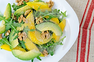 Exotic fruit salad food with mango, avocado, rucol