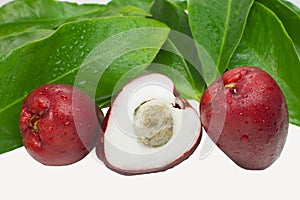 Exotic fruit Syzygium malaccense with leaves and one cut in white background