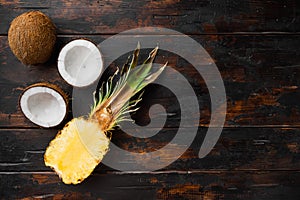 Exotic fruits, pineapple and Coconut, on old dark  wooden table background, top view flat lay, with copy space for text