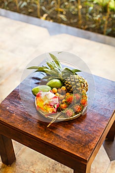 Exotic fruits on plate: mango, dragon fruit; mango; pineapple an