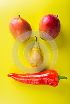 Exotic fruits shaped as funny face on bright background