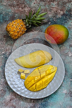 exotic fruits: sliced â€‹â€‹Thai mango, pineapple and whole mango