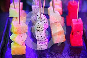 Exotic fruits on sticks for guests