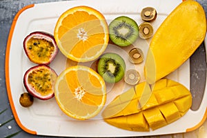 Exotic fruits on white cutting board