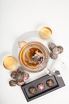 exotic green tea with flowers in glass teapot