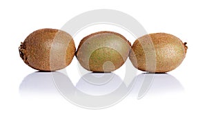 Exotic kiwi full of beneficial vitamins, isolated on a white background. Close-up of three whole kiwis fruit.