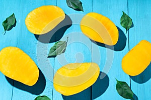 Exotic mango tropical fruit cutted on blue background