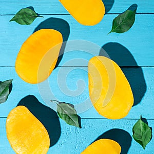 Exotic mango tropical fruit cutted on blue background