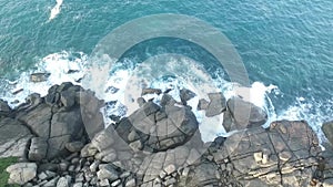 Exotic ocean wave iwith rock from drone