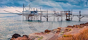 Exotic old wooden fishing pier on popular tourist attraction - Trabocco Turchino. photo