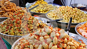 Exotic Oriental Asian sweet delicious desserts, unusual colorful traditional dishes on the counters of a bazar with