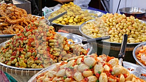 Exotic Oriental Asian sweet delicious desserts, unusual colorful traditional dishes on the counters of a bazar with street food.