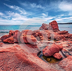 Exotic Red Rocks Gli Scogli Rossi - Faraglioni cliffs on Di Cea beach. photo