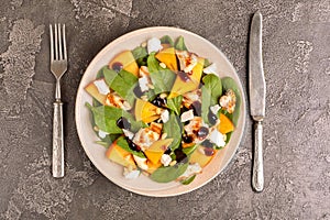 Exotic salad with spinach, persimmon, grilled chicken fillet, feta