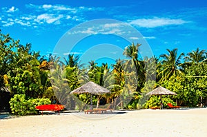 Exotic sandy beach with red stand up paddle board