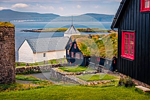 Exotic summer view of Kirkjubour village with turf-top houses, Faroe Islands,  Denmark, Europe. Stunning  morning scene of Hestur