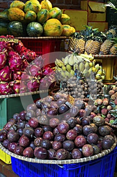 Exotic and tropical fruits on the market of  Thailand, Vietnam. Mini bananas, longan, pitaya Dragon Fruit, papaya