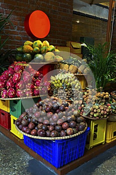 Exotic and tropical fruits on the market of  Thailand, Vietnam. Mini bananas, longan, pitaya Dragon Fruit, papaya