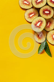 Exotic Tropical Kiwi Red Passion fresh fruits slices on the yellow background