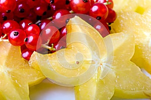 Exotic tropical star fruit and red currant berry photo
