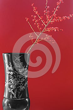 Exotic vase with red berries