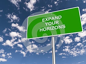 expand your horizons traffic sign on blue sky photo