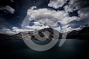 Expanse of Lake Iskander-Kul. Tajikistan. In dark colors