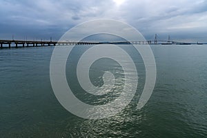 idyllic seascape with a long bridge