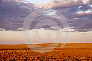 An expansive view of rocky ground under a cloud-laden sky