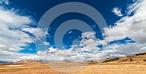 Expansive view of the Sacred Valley, Peru from Pisac Inca site, major travel destination in Cusco region, Peru. Dramatic sky.