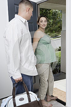 Expectant Couple Exiting Home photo