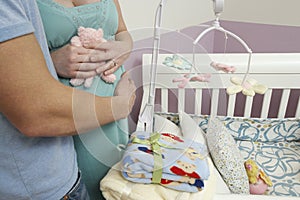 Expectant Couple Standing By Cradle