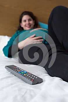 Expectant Mom Relaxing Watching Television at Home