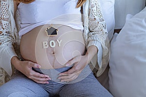 The expectant mother placed a gift and the word boy on her tummy after going for an ultrasound to determine the gender of her