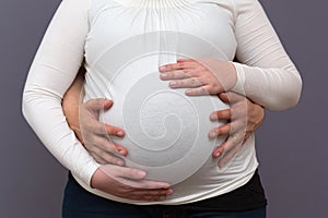 Expectant Parents Holding Growing Baby Bump
