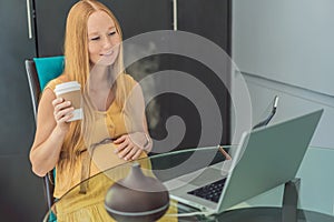 Expectant woman enhances work environment, using an aroma diffuser for a soothing atmosphere during pregnancy