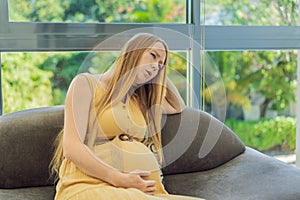 Expectant woman experiences discomfort, feeling unwell during pregnancy photo
