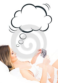 Expectant woman holding an x-ray of an embryo with a cloud