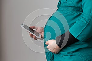 Expectant Young Mom Searching on Her Smartphone