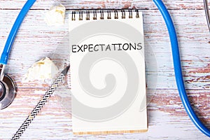 EXPECTATIONS the text is written on a notebook
