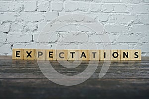 Expectations word alphabet letters on wooden background