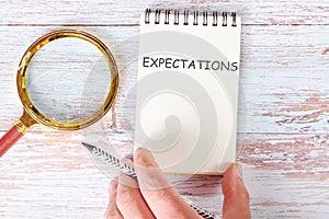 EXPECTATIONS written on a blank sheet of a notebook
