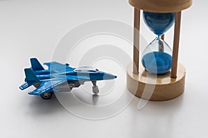 Expected time of arrival, flight delay and arrival concept. plane on hourglass with copy space for text