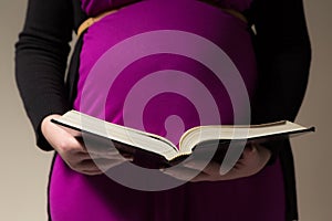 Expecting Mom Holding The Holy Bible photo