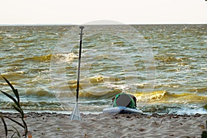 Expedition stand up paddleboard, a paddle and a sup Board on the shore,