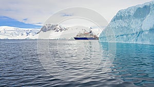 Expedition vessel in front of Antarctic iceberg landscape at Portal Point