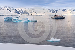 Expedition vessel in front of Antarctic iceberg landscape at Portal Point