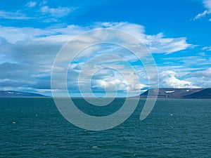 Expeditions cruise in the arctic ocean with view of die mountain landscape. Svalbard.