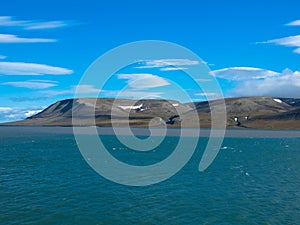 Expeditions cruise in the arctic ocean with view of die mountain landscape. Svalbard.