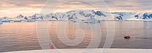Expeditions - Zodiac with tourists cruises through Antarctic iceberg landscape at Portal Point
